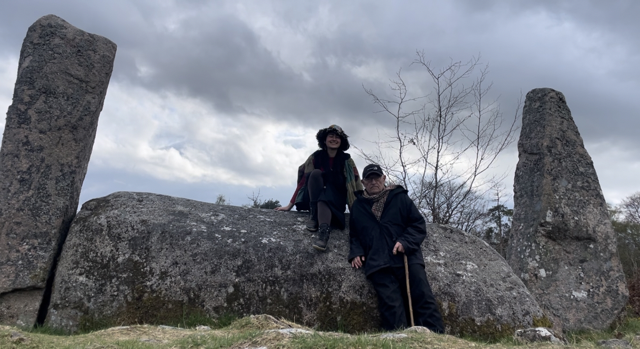 nera and their dad with a recumbant stone