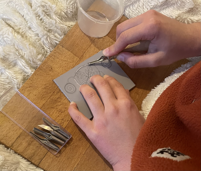 nera is carving a linocut block